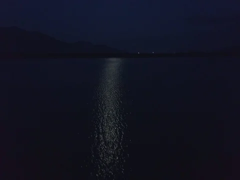 Drone Flies over Moon Reflection on Lake Surface at Night 스톡 동영상 81262616