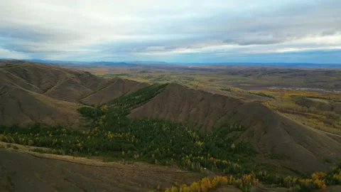Drone flies over mountain range in golden autumn Stock Footage 220089514
