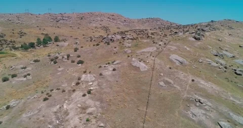A drone flies over a mountain road among the hills Stock Footage 255871122