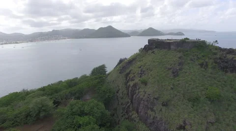 Drone flies over mountain with view of sea and landscape - Saint Lucia Stock Footage 61859420