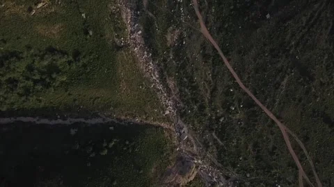 A drone flies over mountains covered with greenery on a sunny spring day Stock Footage 311791453