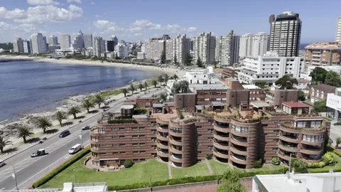 Drone flies over Muelle de Mailhos toward Playa La Pastora on sunny afternoon Stock Footage 297725663
