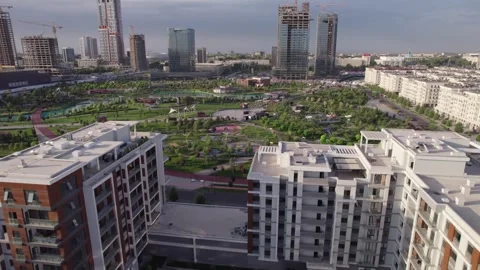 A drone flies over newly built high-rise buildings Stock Footage 255187425
