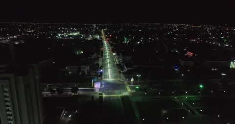 The drone flies over the night illuminated square next to the ancient complex Stock Footage 310498658