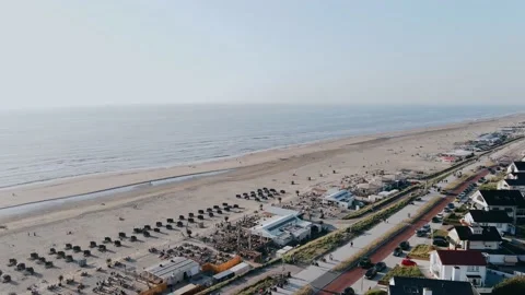 Drone flies over ocean beach in the city on a summer day Video stock 196837243