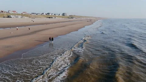Drone flies over ocean beach in the city on a summer day Vídeo Stock 196837363
