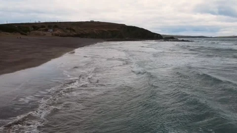 Drone flies over the ocean beach in cloudy weather, Ireland Video stock 267077189