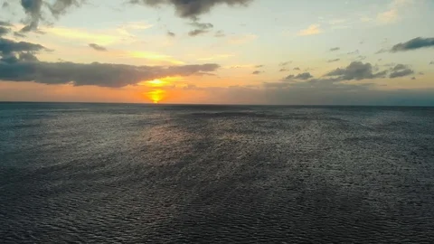 Drone flies over ocean during the sunset Stock Footage