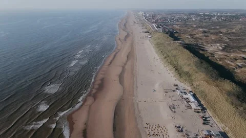 Drone flies over ocean shore outside the city on a sunny day Vídeo Stock 196837459
