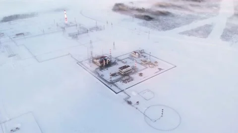 A drone flies over an oil and gas production facility during winter time during Stock Footage