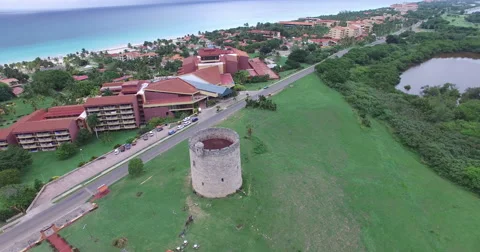 Drone flies over an old stone tower on the field. Bird's-eye view at city Stock Footage 65537931