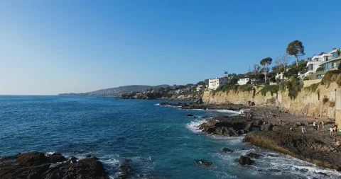 Drone flies over pacific beach and water surface at Laguna Beach, California Stock Footage 157772074