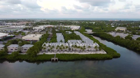 Drone flies over Parrot Key Hotel and Villas in Key West, showcasing waterfront Stock-Footage 321519384