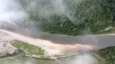 The drone flies over the river and the fog to the left Stock Footage 137968772