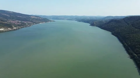 Drone flies over river Danube in a valley of wooded hills in sunny autumn day Stock Footage 263141866