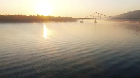 Drone flies over the river, haze and fog. pedestrian bridge Stock Footage 185568542