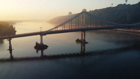 Drone flies over the river, haze and fog. pedestrian bridge Stock Footage 185570776