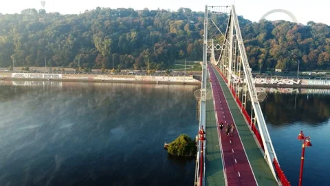 Drone flies over the river, haze and fog.people are walking on the bridge. Stock-Footage 185575531