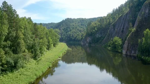 A drone flies over the river repeating its turn. Stock Footage 114976183