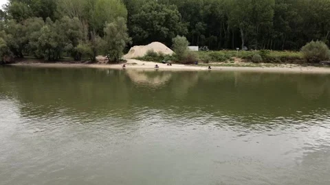Drone flies over river towards fishermen on a shore Stock Footage 269540331
