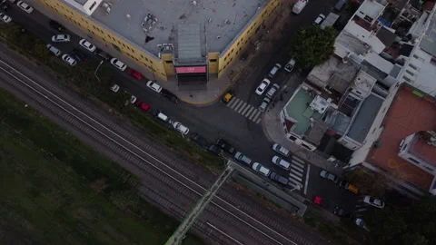 The drone flies over the road running parallel to the railway tracks Stock-Footage 246404313