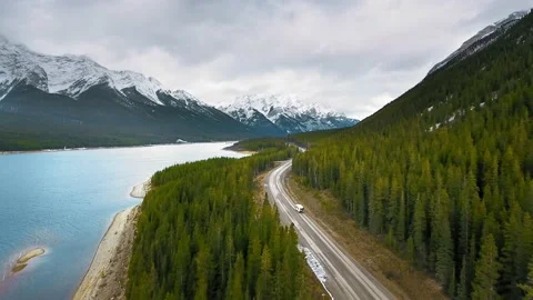 Drone flies over the road through the green forest in Alberta, Canada Video stock 137512168