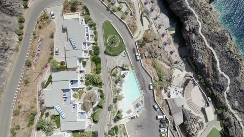 Drone flies over the rocks and Kalypso beach village. Volcanic archipelago Video stock 168250377