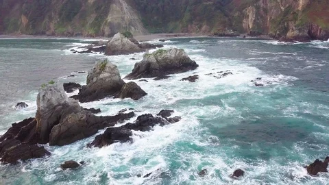 Drone flies over rocks in the ocean Stock Footage 86113696