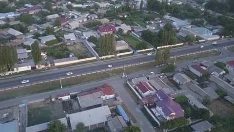 The drone flies over the roofs of one-story houses. A sunny summer day. Stock Footage 311791515