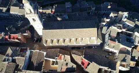 Drone flies over the rooftops and roof of mediterranean village church Stock Footage 124223310