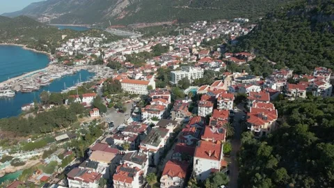 A drone flies over rooftops in a city by the sea in Turkey. Near Greece Stock Footage 215247674