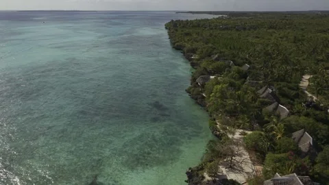 Drone flies over seaside resort and along coast kissing turquoise waters Stock-Footage 346481388