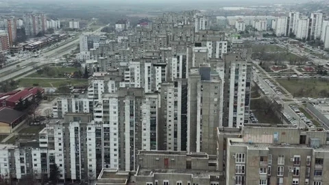 Drone Flies Over a Series of Brutalist Buildings and Pans up to an Overcast Sky Video stock 148474656