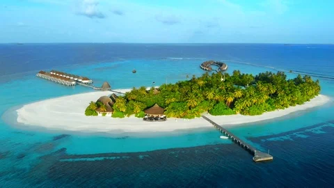 Drone flies over the small tropical atoll island resort with white sandy beach Stock Footage