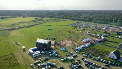 A drone flies over the stage surrounded by many people against the backdrop Stock Footage 158609134
