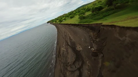 The drone flies over the steep shore of the ocean Stock Footage 253479903