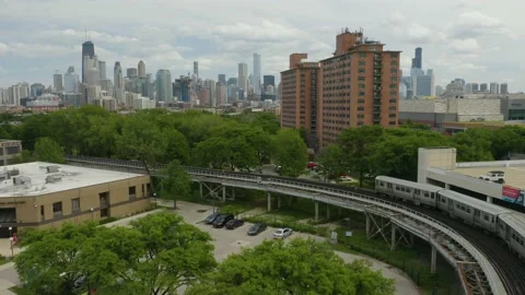 Drone Flies Over Subway Train and Apartment Building to Reveal Chicago's Skyline Stock Footage 132538268