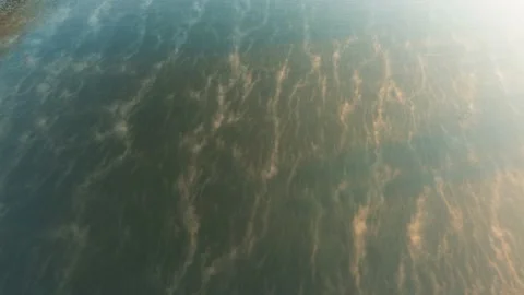 Drone flies over the surface of the river, the haze illuminated by the morning Stock Footage 185575681