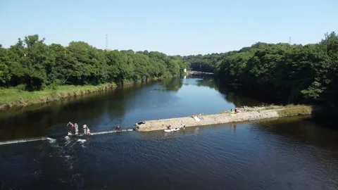 Drone flies over swimmers, River Lune, August 2022 heatwave Stock Footage 204773788