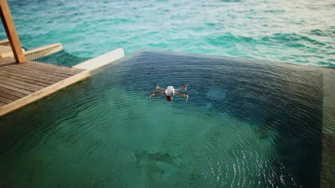 A drone flies over a swimming pool in the Maldives Stock Footage 240331462
