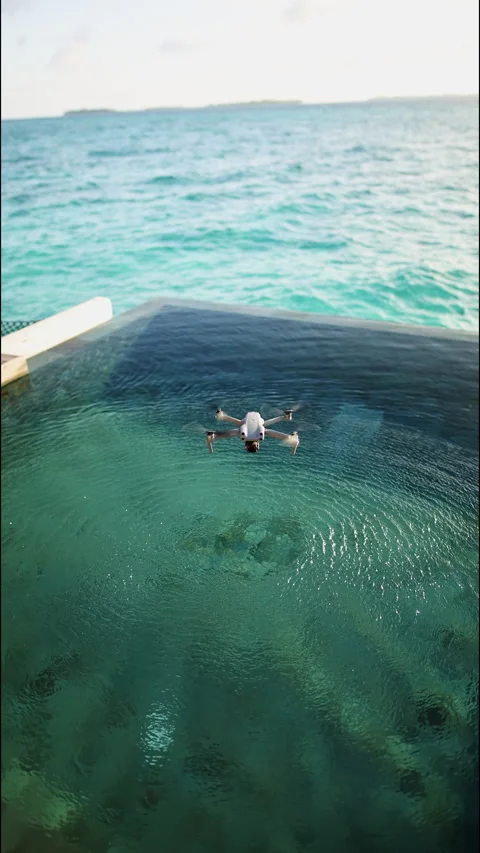 A drone flies over a swimming pool in the Maldives. Vertical footage Stock Footage 260340789