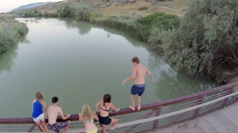 Drone Flies Over Teens As They Prepare To Jump Off A Bridge Into River Below Stock-Footage 47495210
