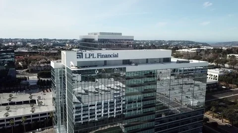 Drone flies over top of office building with mirrored windows and pulls back Stock Footage 84950233