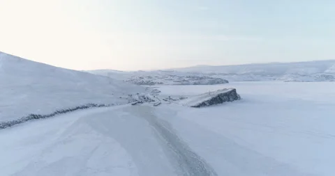 Drone Flies Over the Trail Left by a Ship on the Ice of a Frozen Lake Baikal Video stock 139029573
