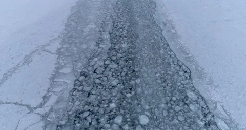 Drone Flies Over the Trail Left by a Ship on the Ice of a Frozen Lake Baikal Stock Footage 140076182