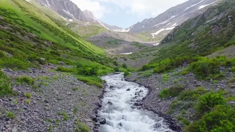 The drone flies over a transparent mountain river in the highlands Stock Footage 166267358