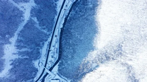 Drone flies over trees with snow  in the forest and river  in winter Stock Footage 147552364