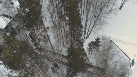 The drone flies over the treetops under which there is a bridge to the estate in Stock Footage 151692373