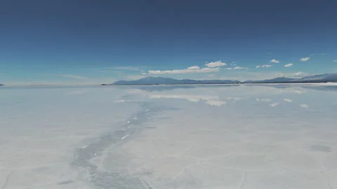Drone flies over the water surface in the natural salt flat of Salinas Stock Footage 274706805