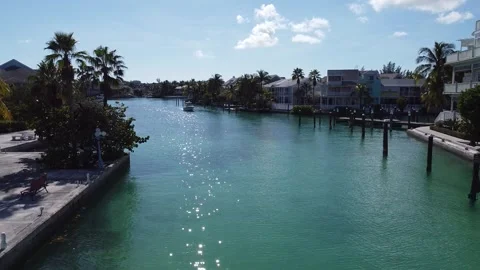 Drone flies over water toward condos Stock Footage 257941474